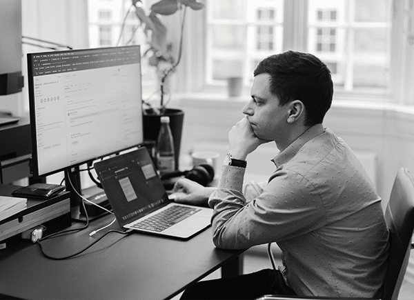 Photo of man looking at computer screen