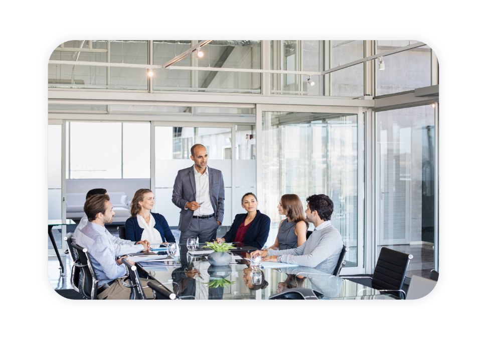 A team sits in a sleek office and has a meeting.