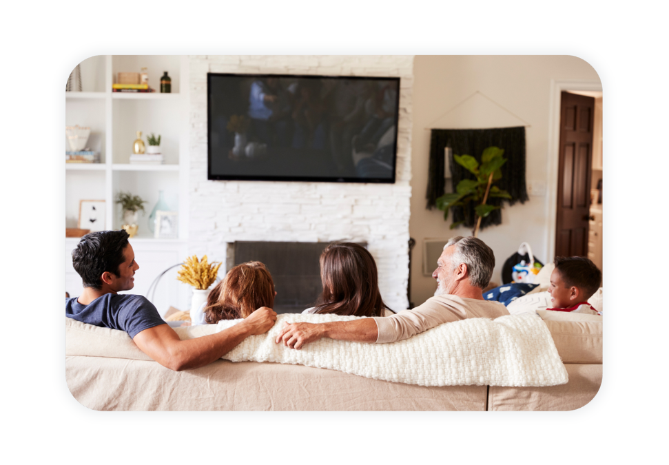 A family watches TV in their home